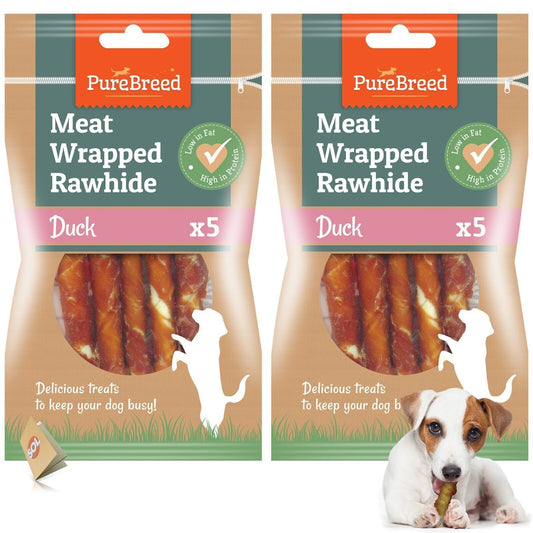 Two packages of PureBreed Meat Wrapped Rawhide Dog Treats with a picture of a dog chewing on one of the treats.